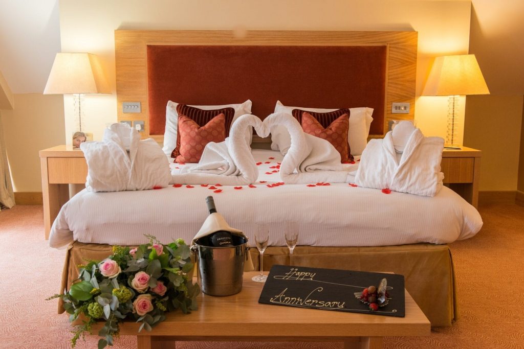 Image of EAST SUSSEX NATIONAL HOTEL bedroom with champagne and flowers