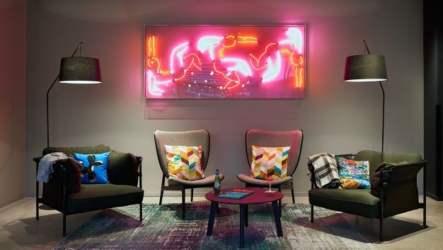 Image of seating area with vibrant neon artwork at the Moxy Hotel Bristol.