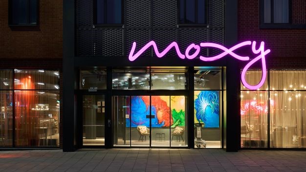 Image of the exterior of the Moxy Hotel Bristol, showing the pink neon sign. 